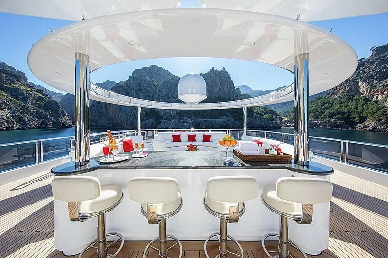 a table with chairs and a large white tent on a deck aboard EMINENCE Yacht for Sale