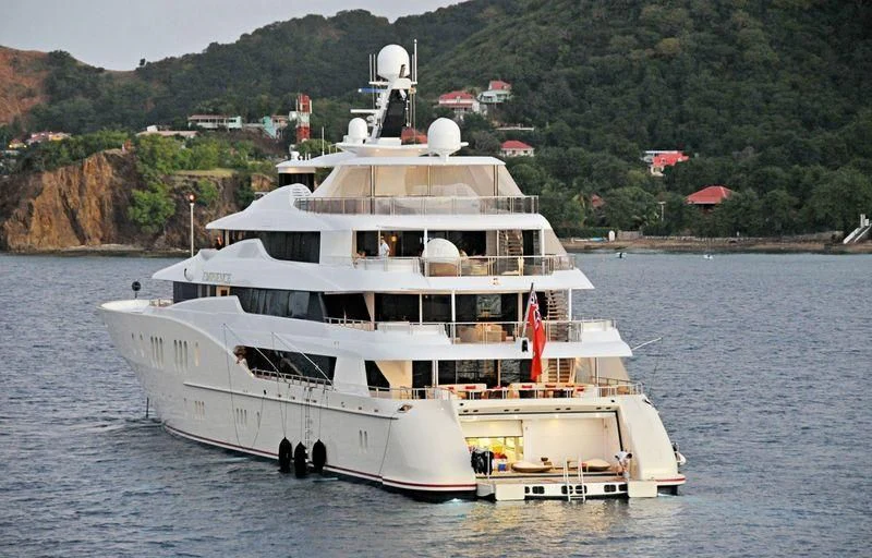 a large white boat on the water aboard EMINENCE Yacht for Sale