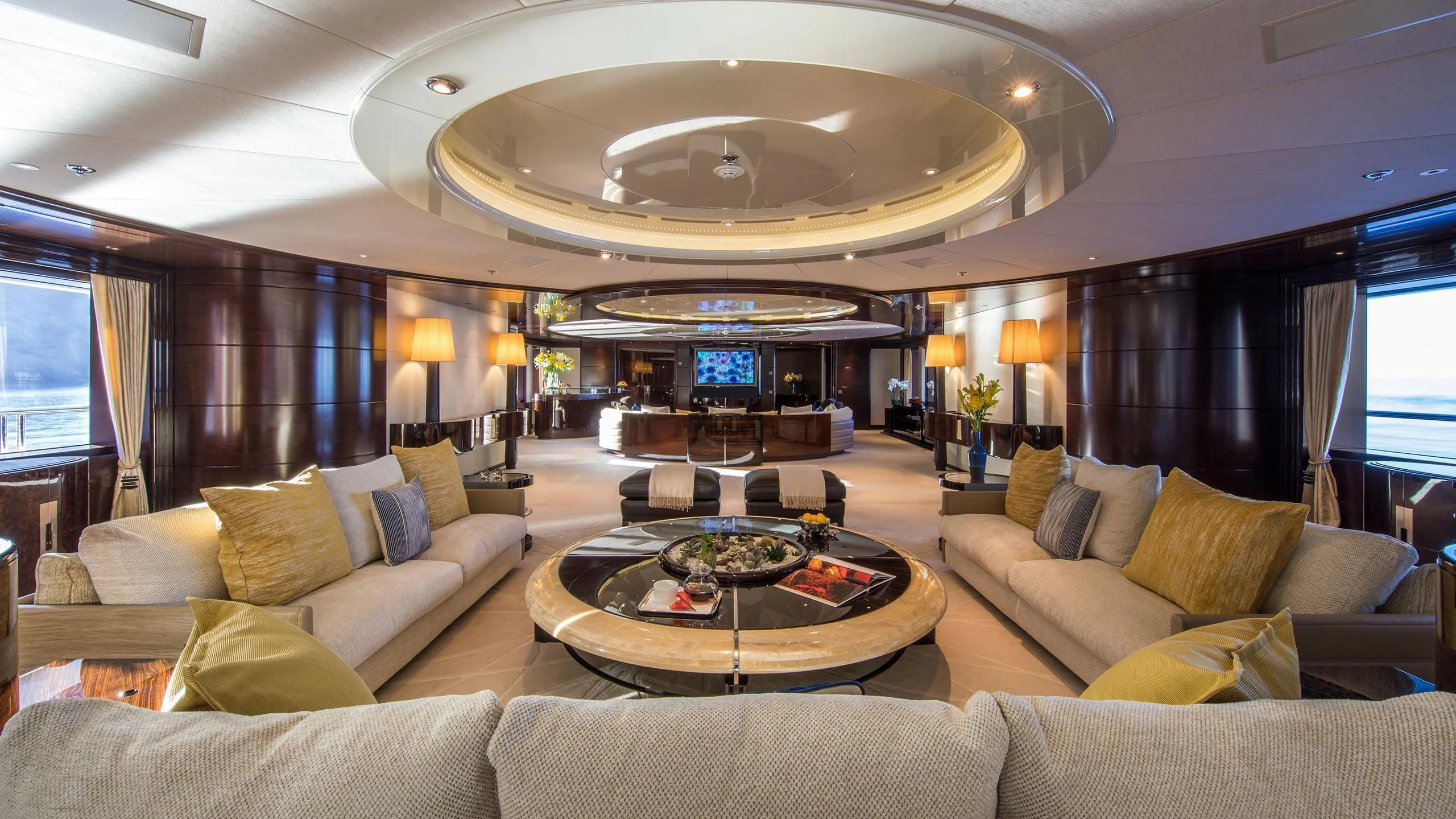 a living room with a large chandelier aboard EMINENCE Yacht for Sale