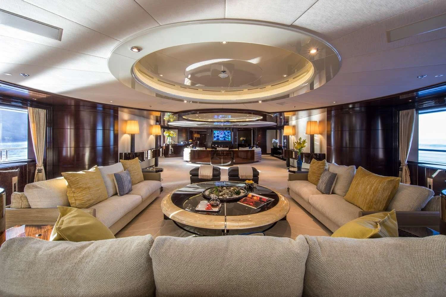 a living room with a large chandelier aboard EMINENCE Yacht for Sale