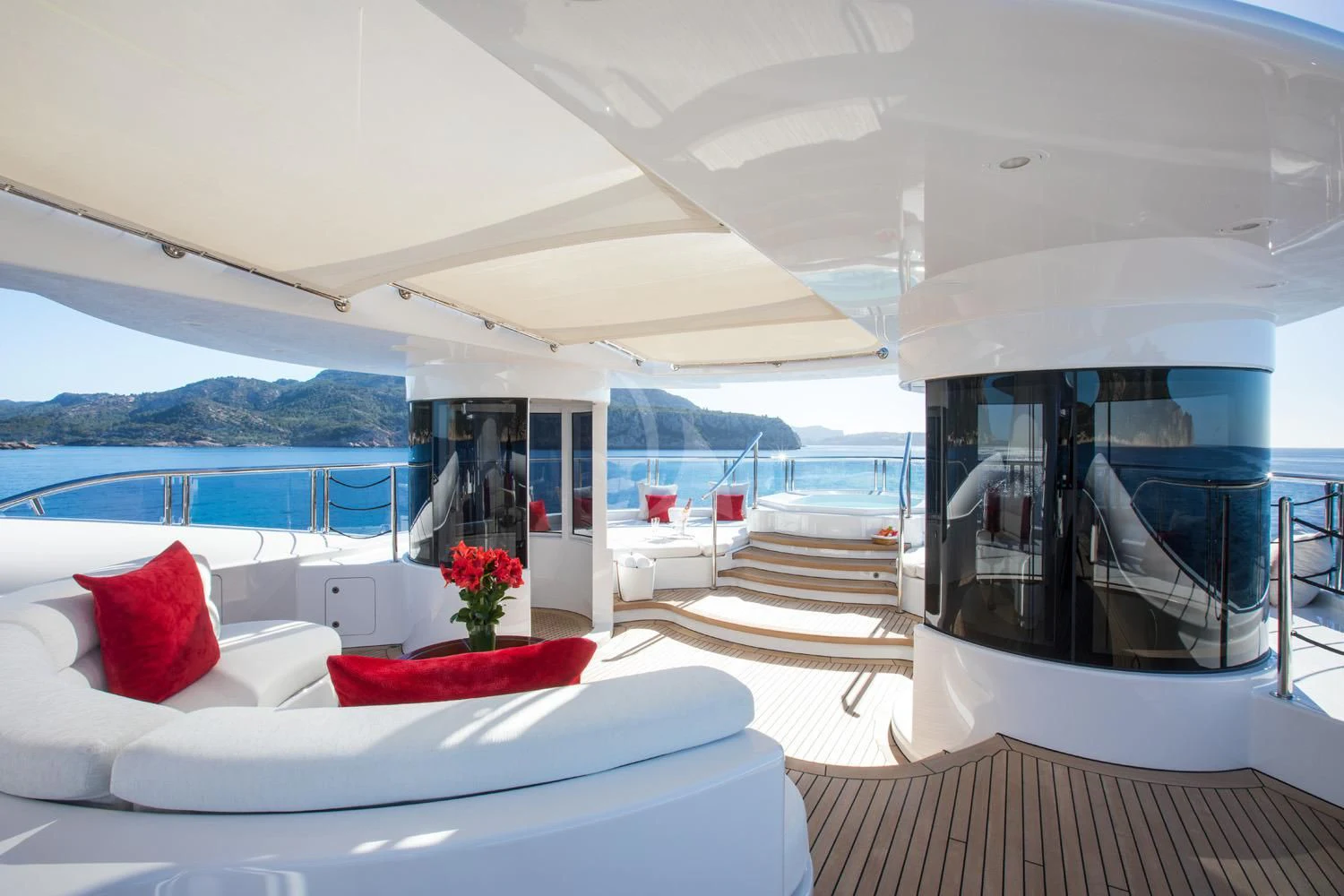 a room with a large bed and a large window aboard EMINENCE Yacht for Sale