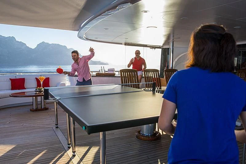 a person playing ping pong aboard EMINENCE Yacht for Sale