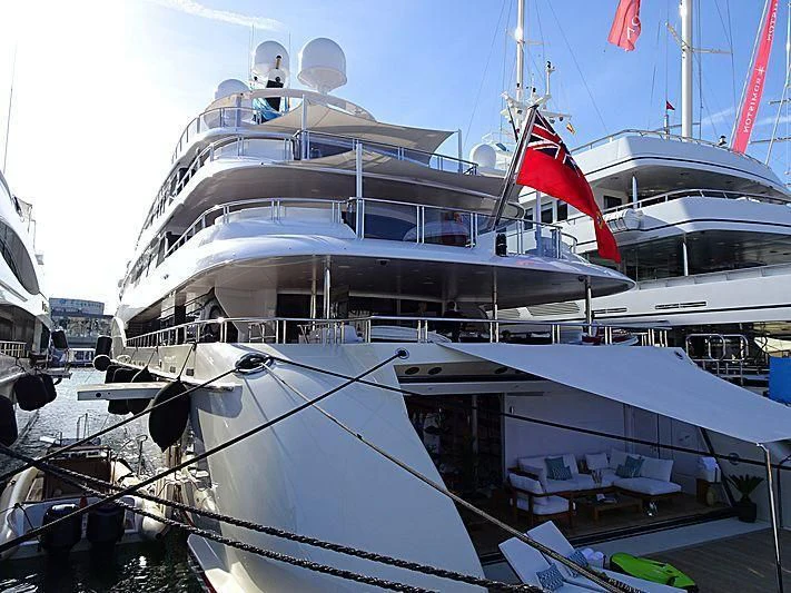 a large white boat with red sails aboard EMINENCE Yacht for Sale