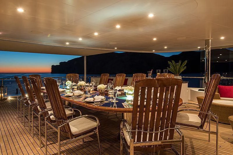 a table set for a dinner party aboard EMINENCE Yacht for Sale