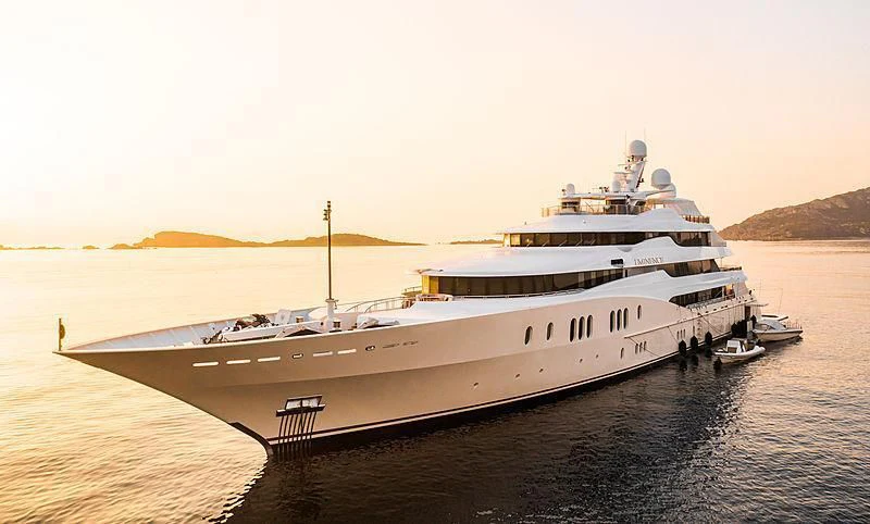 a large white ship on a body of water aboard EMINENCE Yacht for Sale