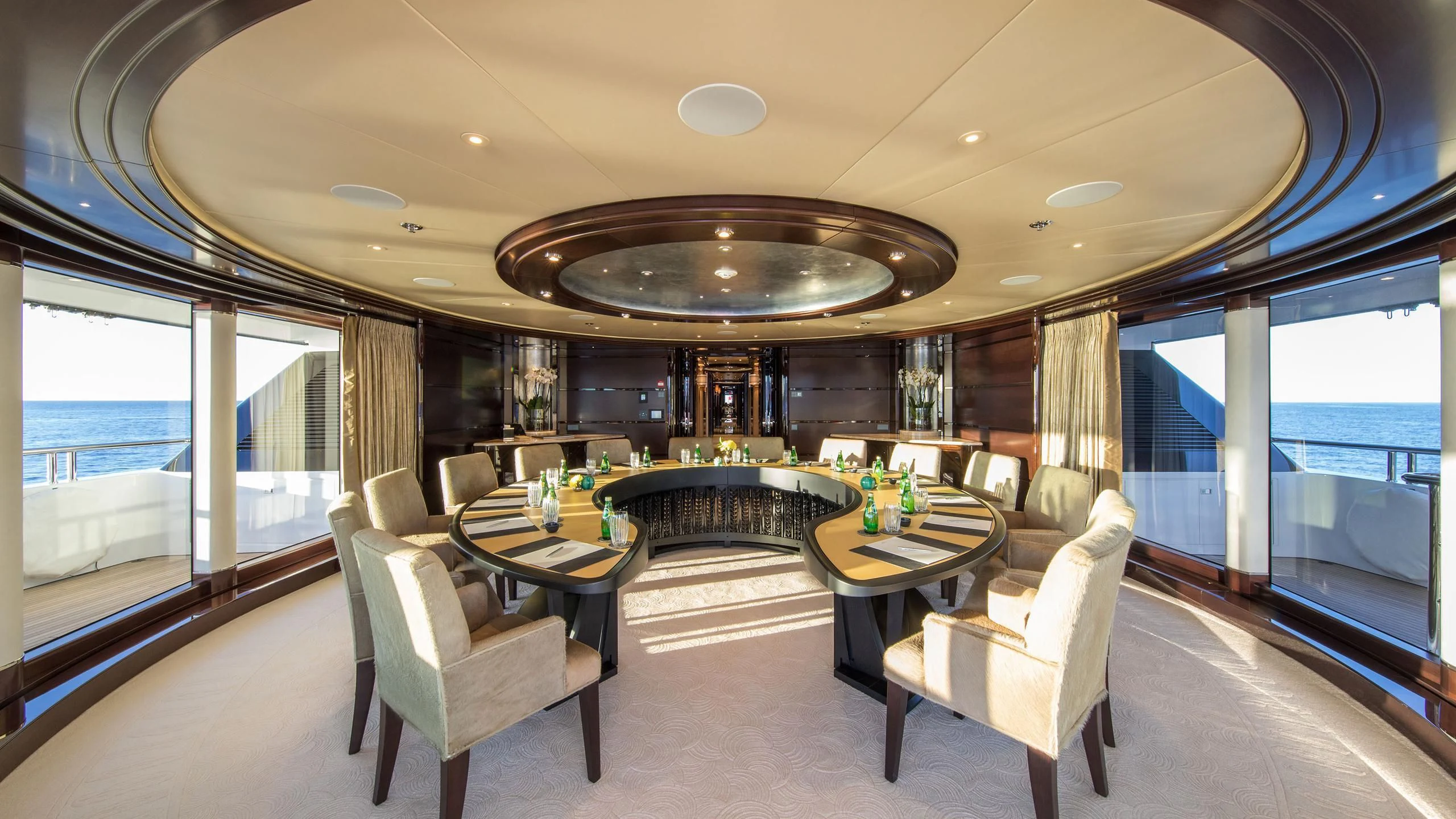 a room with a table and chairs aboard EMINENCE Yacht for Sale