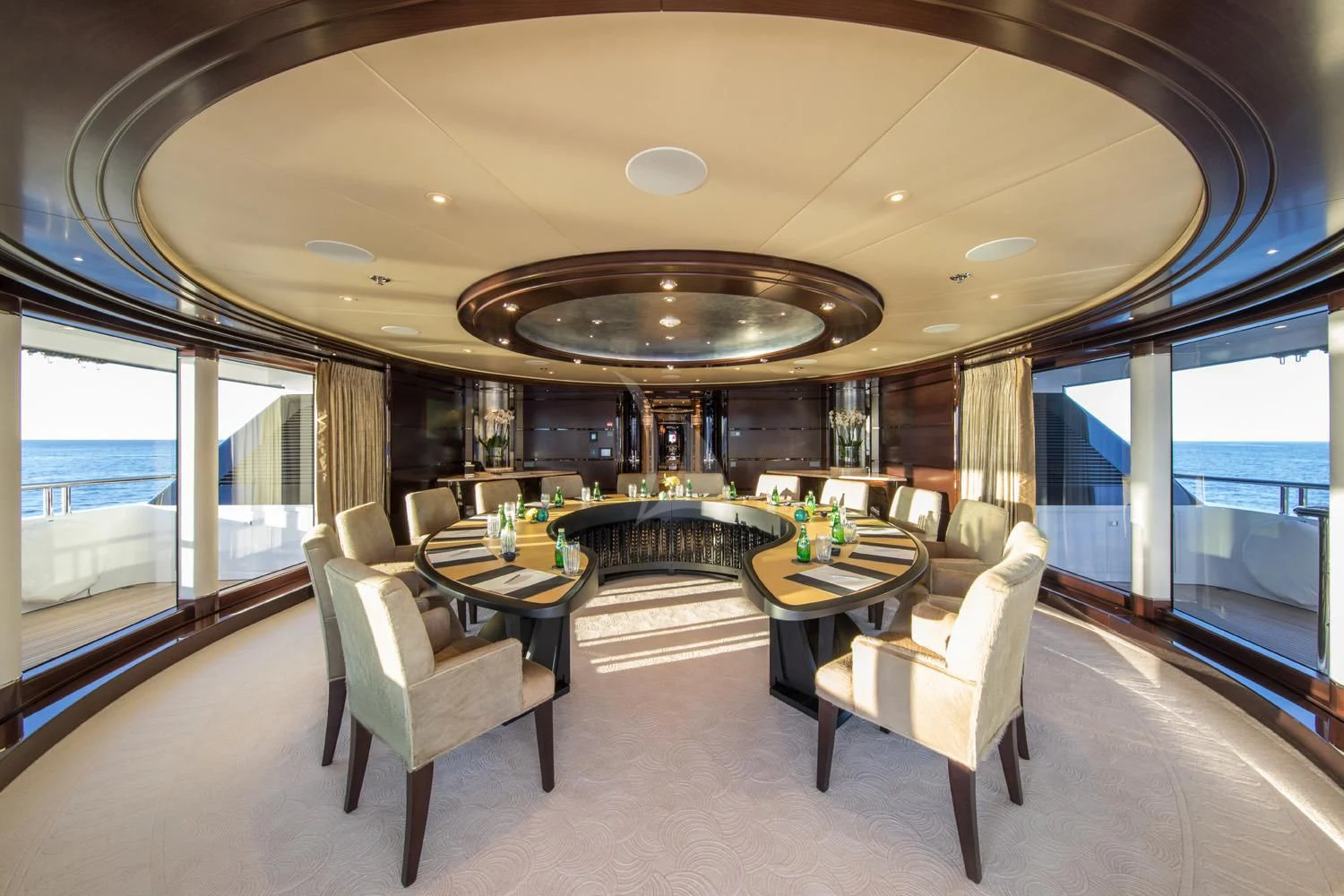 a room with a table and chairs aboard EMINENCE Yacht for Sale