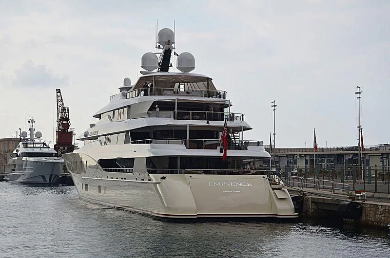 a large white ship docked aboard EMINENCE Yacht for Sale
