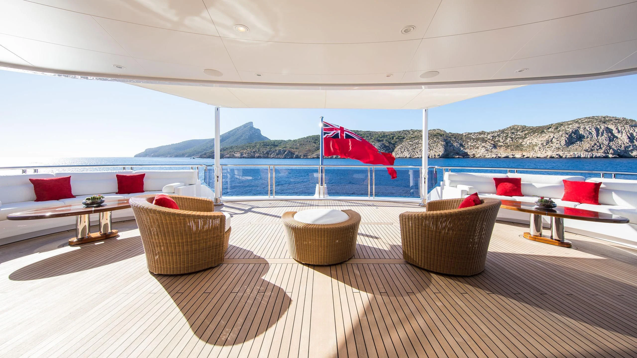 a room with a large deck and a large body of water aboard EMINENCE Yacht for Sale