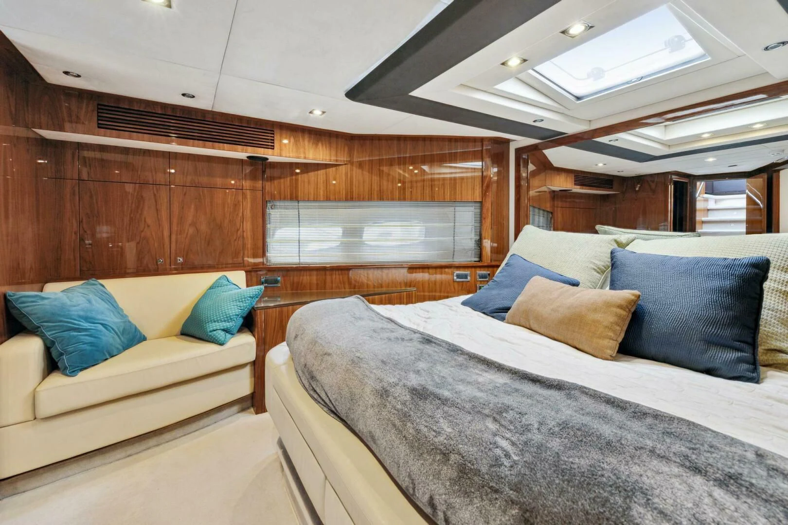 a room with a bed and a couch aboard THE CABANA Yacht for Sale