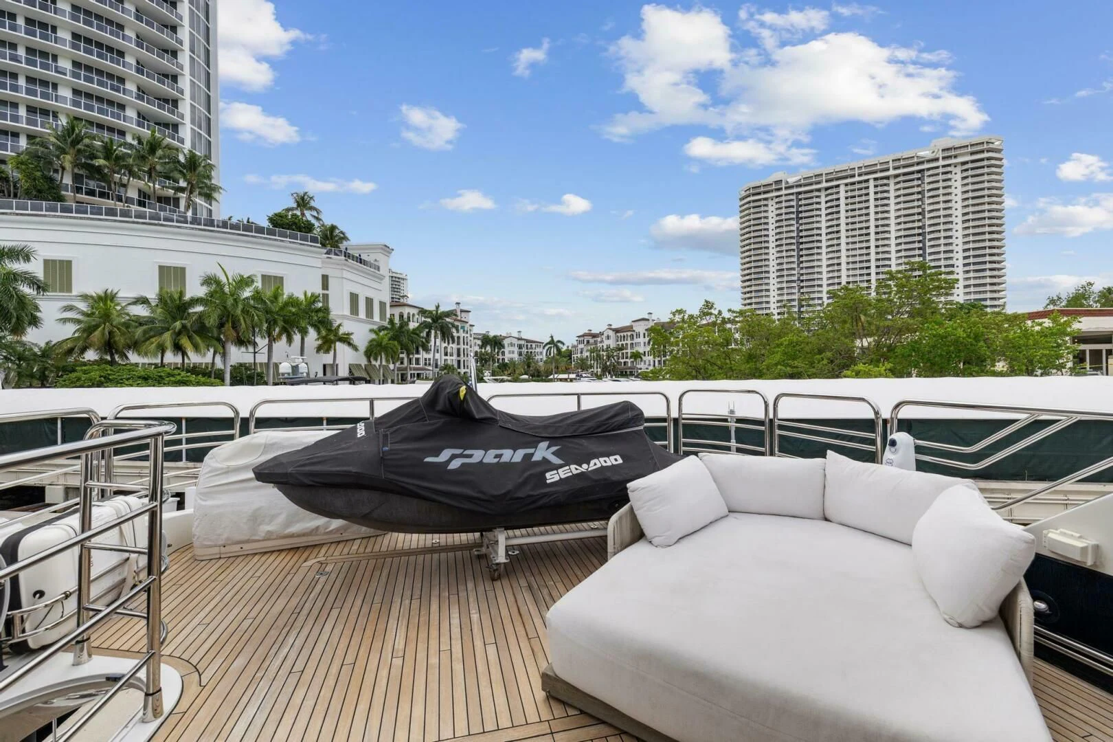 a deck with a large pool and a lounge chair on it aboard THE CABANA Yacht for Sale