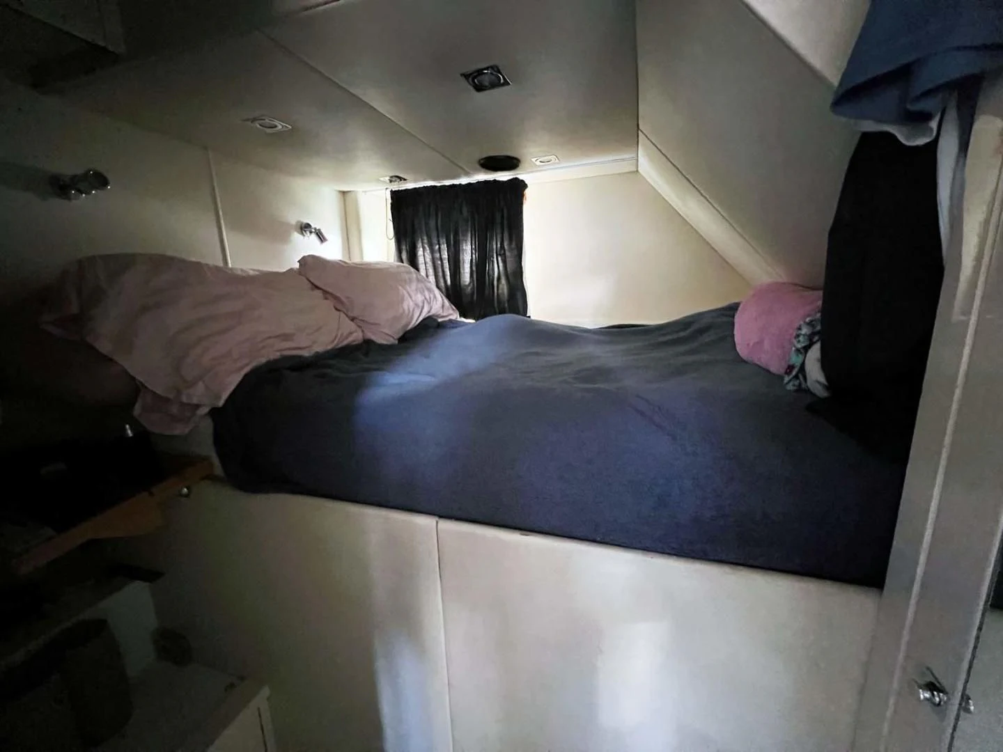 a bed with a blue sheet aboard THE CABANA Yacht for Sale