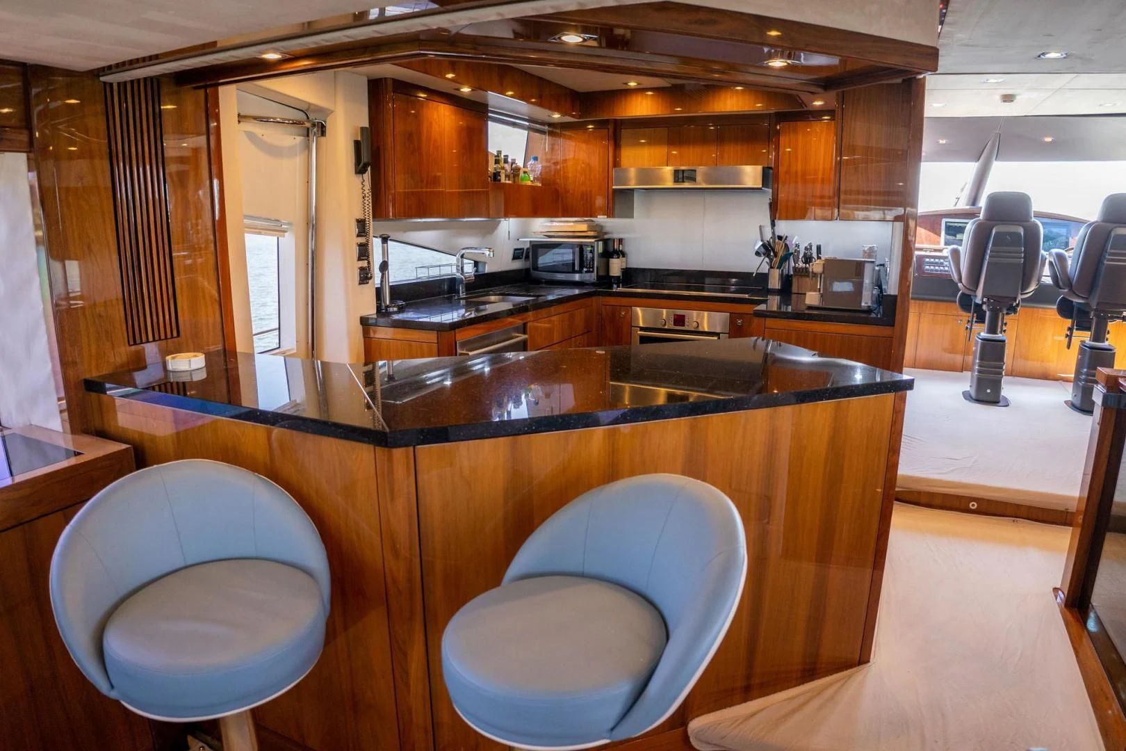 a kitchen with wooden cabinets aboard THE CABANA Yacht for Sale