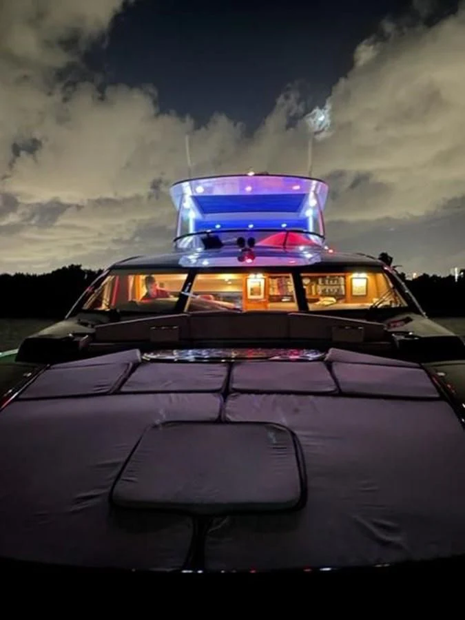 a car with a blue and red stripe and a blue car with a blue stripe and a white aboard THE CABANA Yacht for Sale