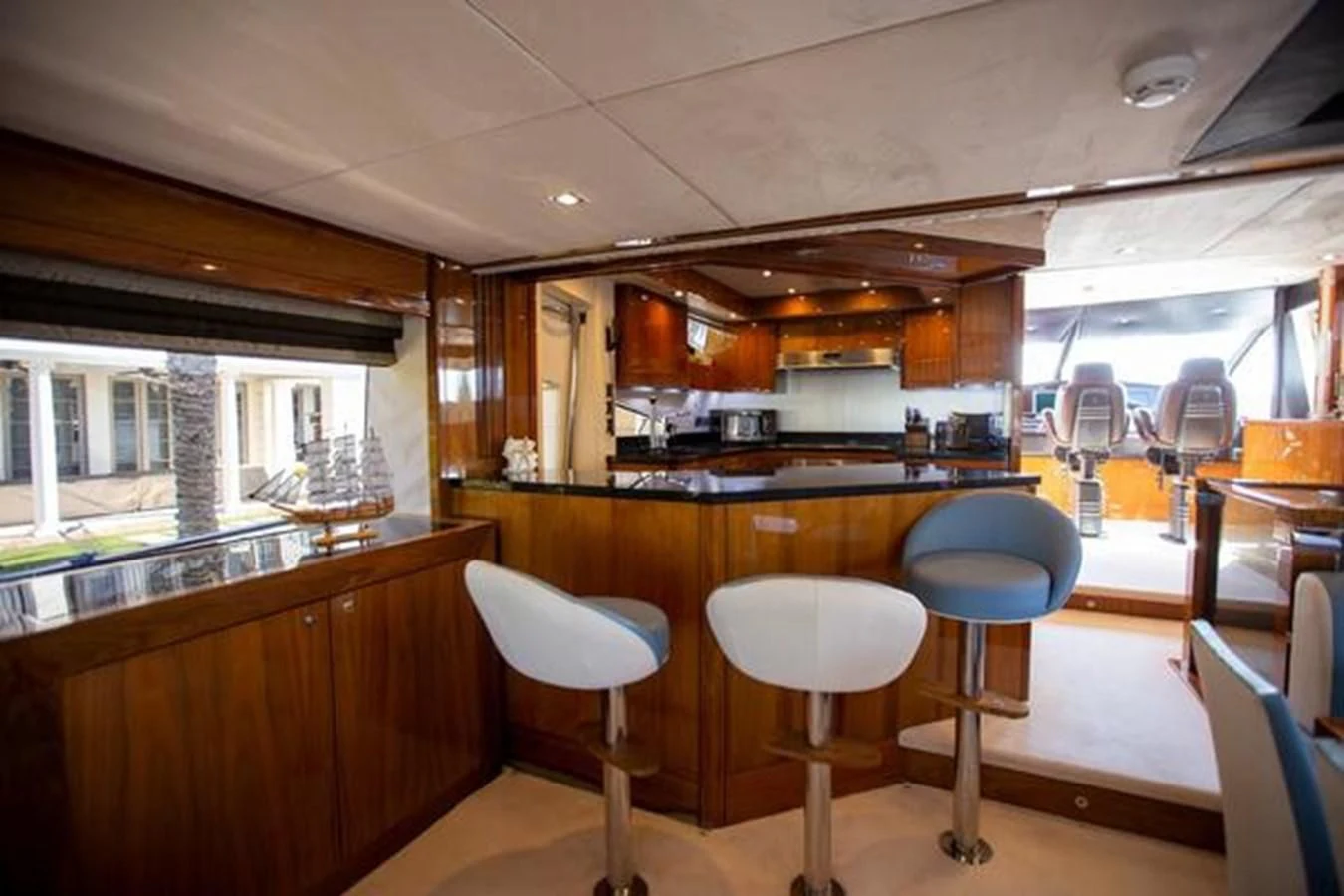 a kitchen with stools and tables aboard THE CABANA Yacht for Sale