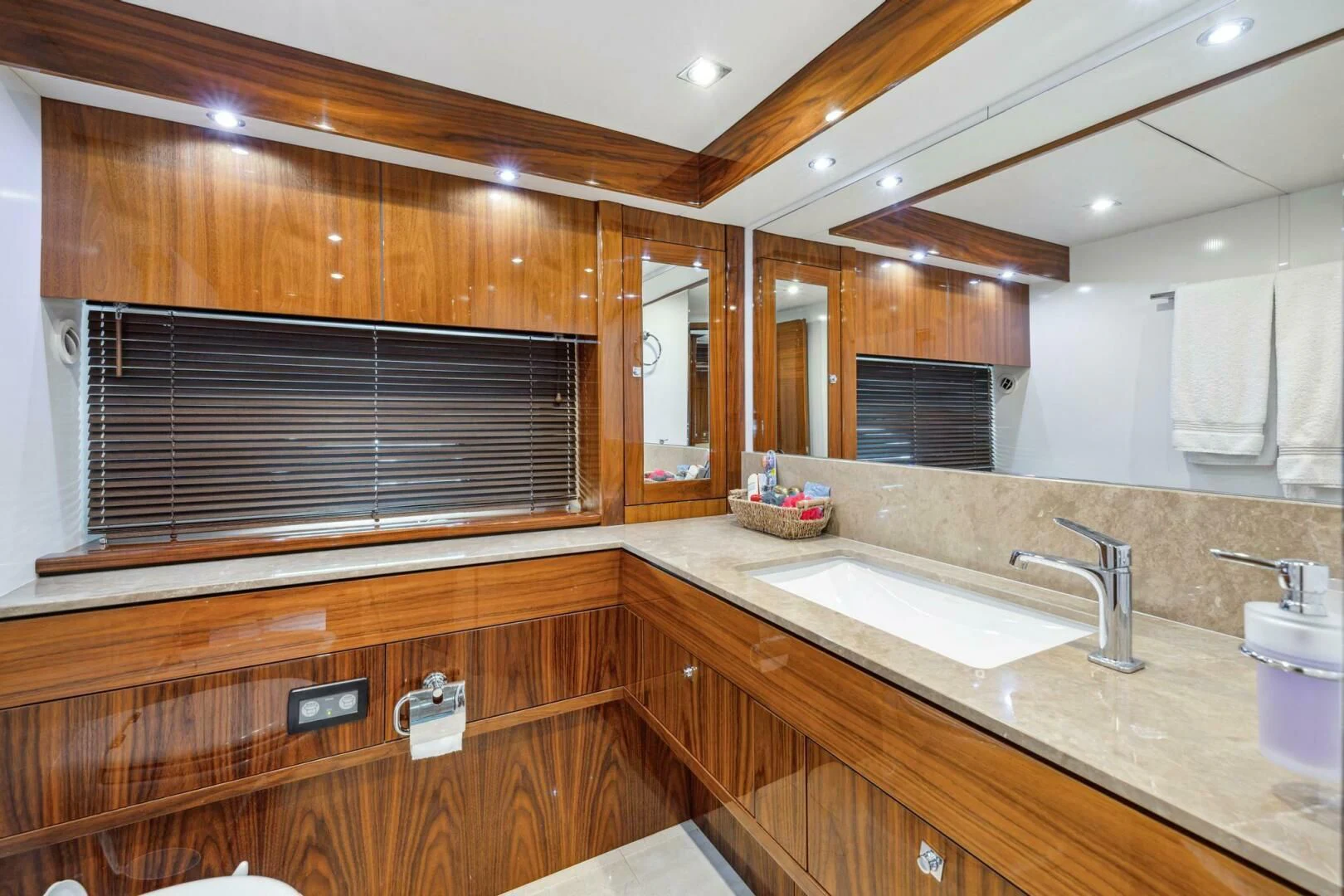 a bathroom with wooden cabinets aboard THE CABANA Yacht for Sale