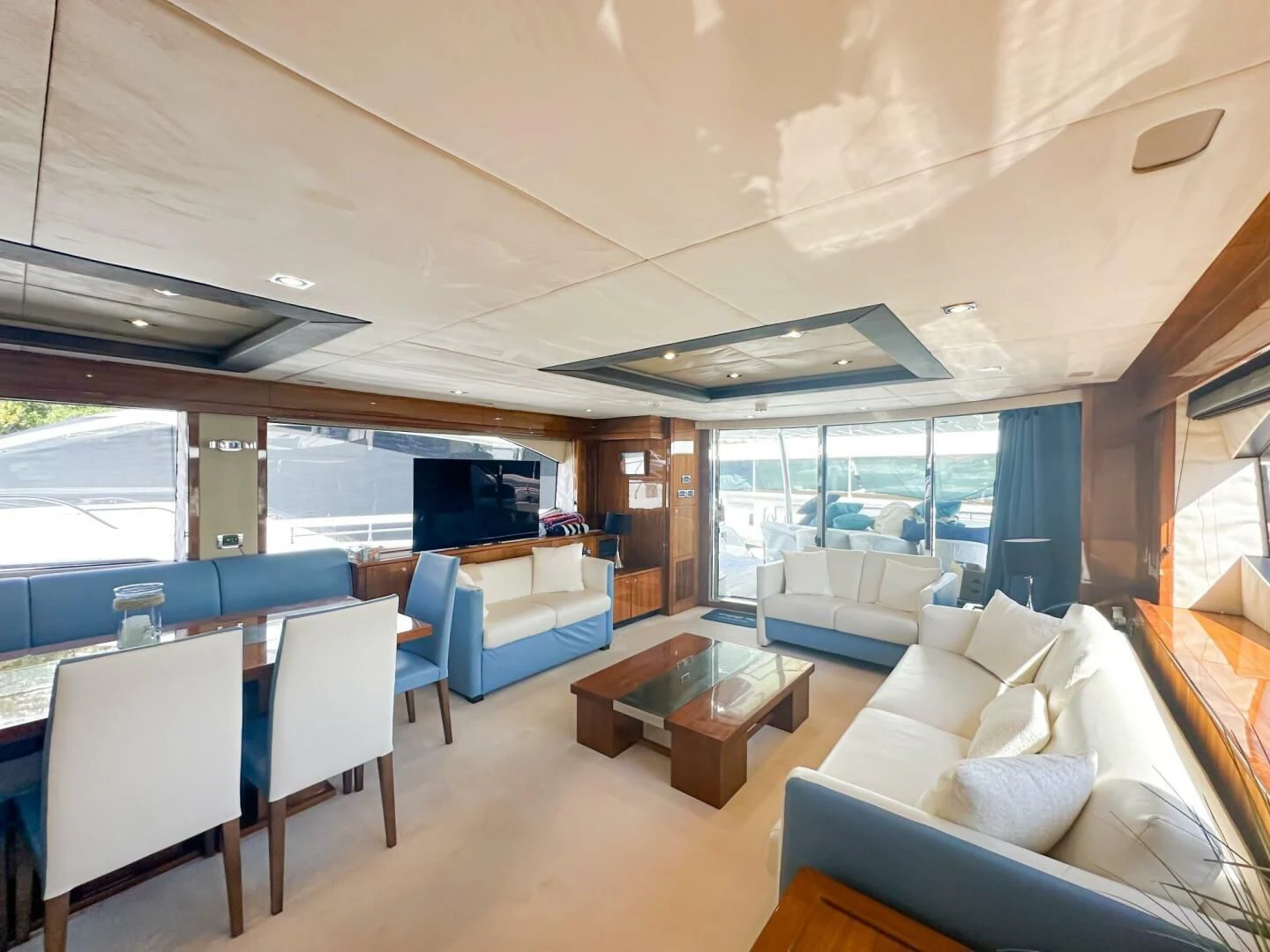 a room with a table chairs and a couch aboard THE CABANA Yacht for Sale