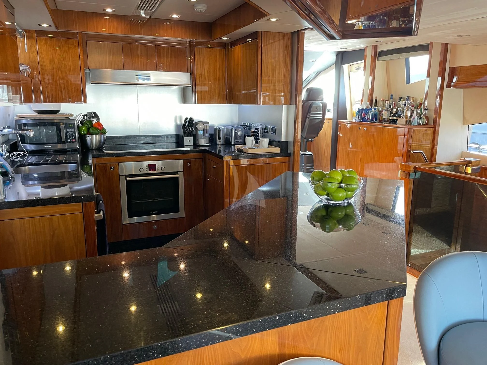a kitchen with wooden cabinets aboard THE CABANA Yacht for Sale