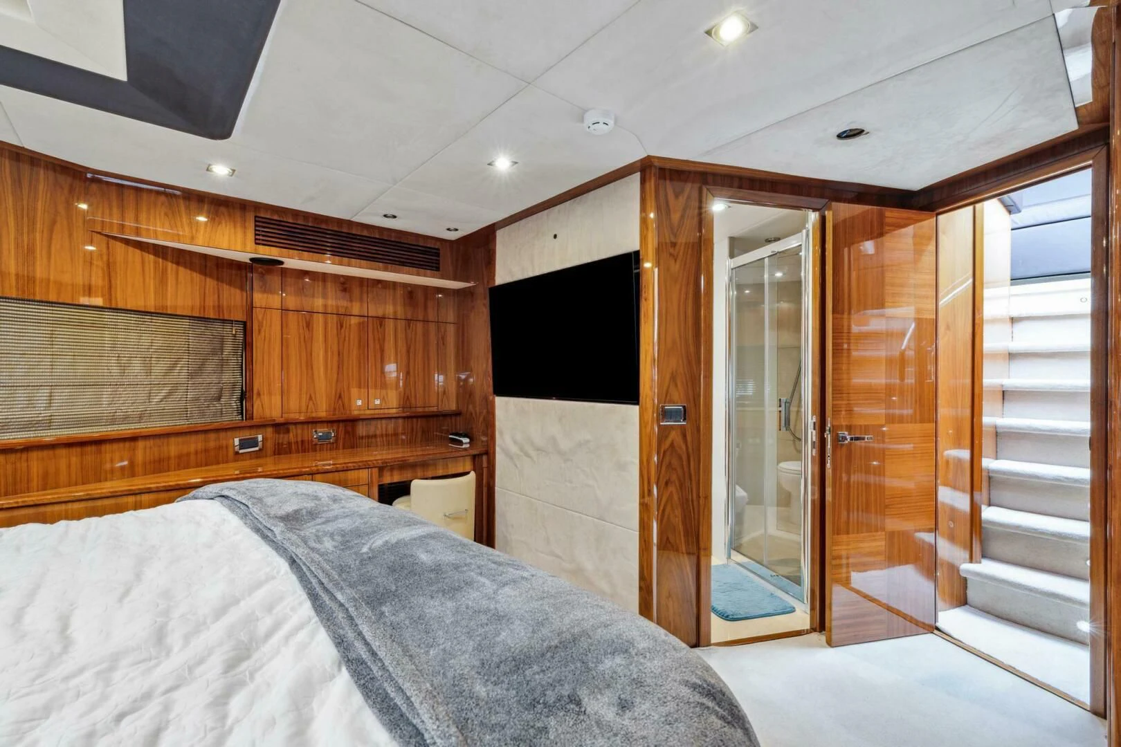 a bedroom with a bed and a closet aboard THE CABANA Yacht for Sale
