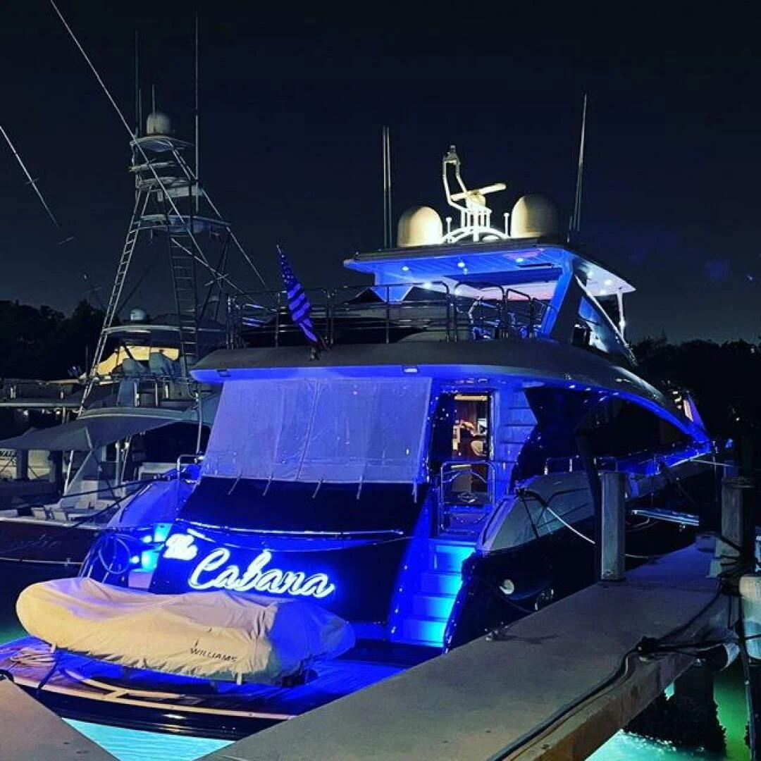 a boat with a blue canopy aboard THE CABANA Yacht for Sale
