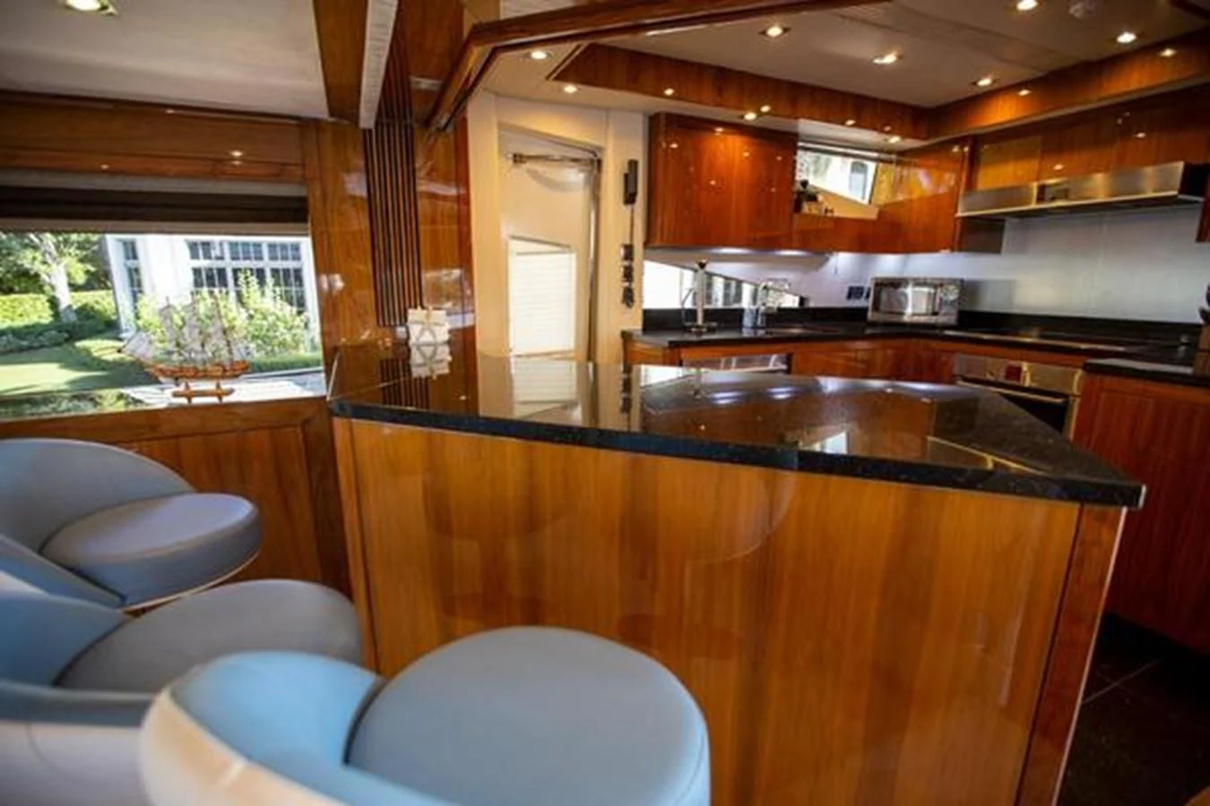 a kitchen with wooden cabinets aboard THE CABANA Yacht for Sale