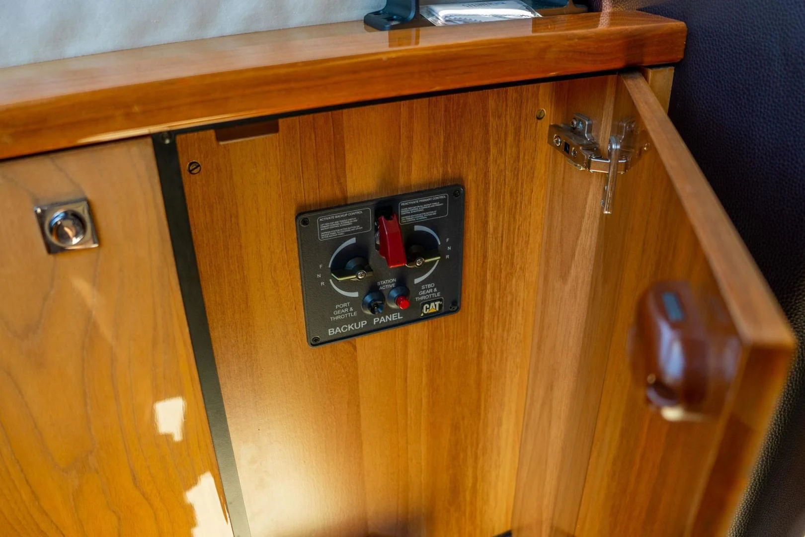 a black rectangular object on a wooden surface aboard THE CABANA Yacht for Sale