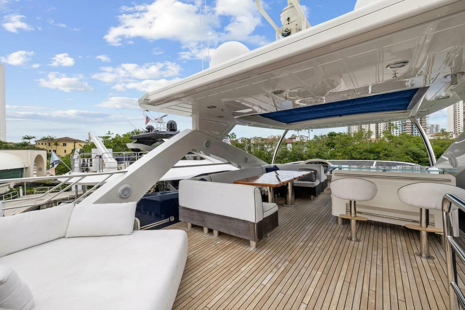 a deck with tables and chairs aboard THE CABANA Yacht for Sale