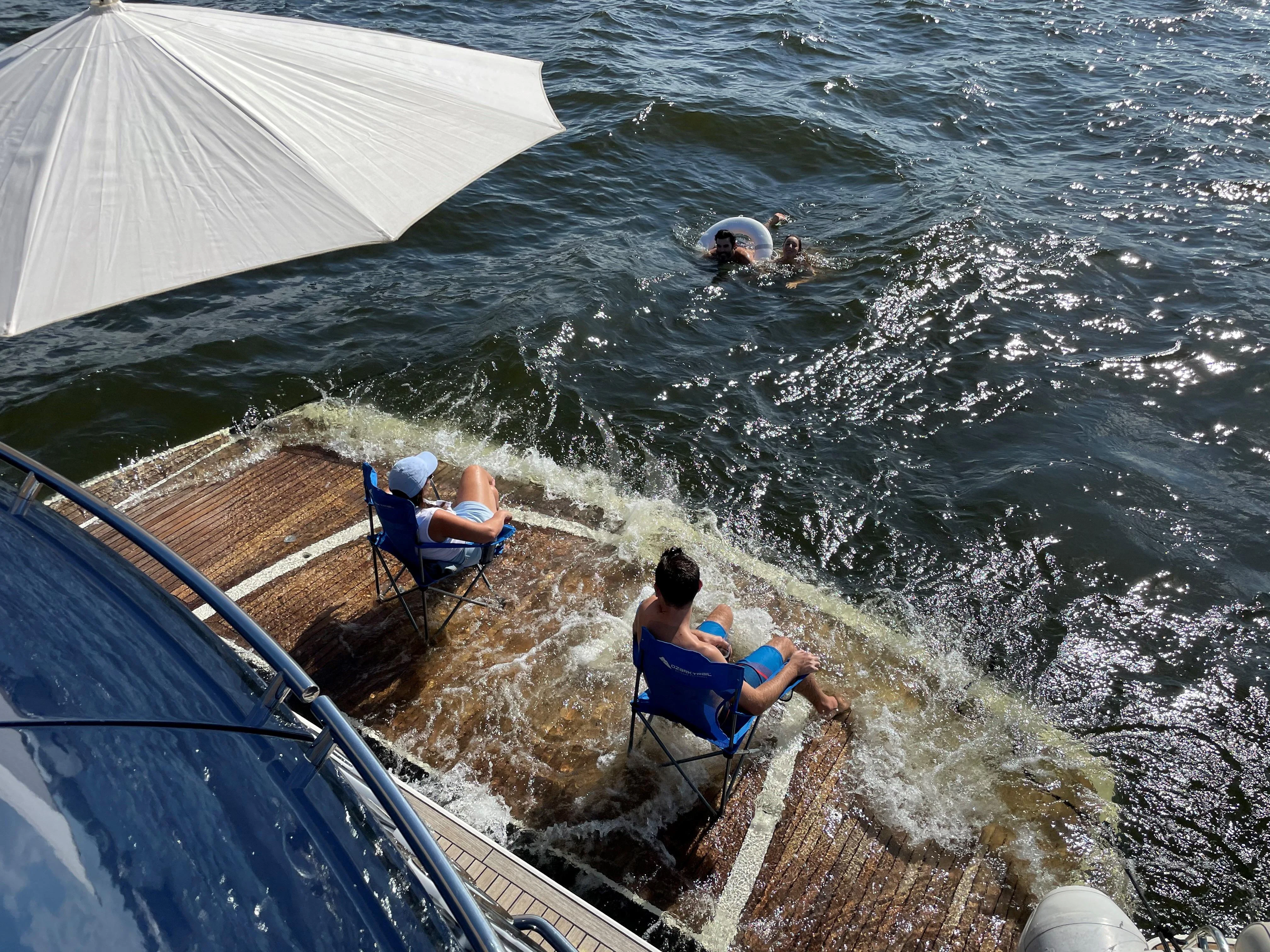 people swimming in a river aboard THE CABANA Yacht for Sale