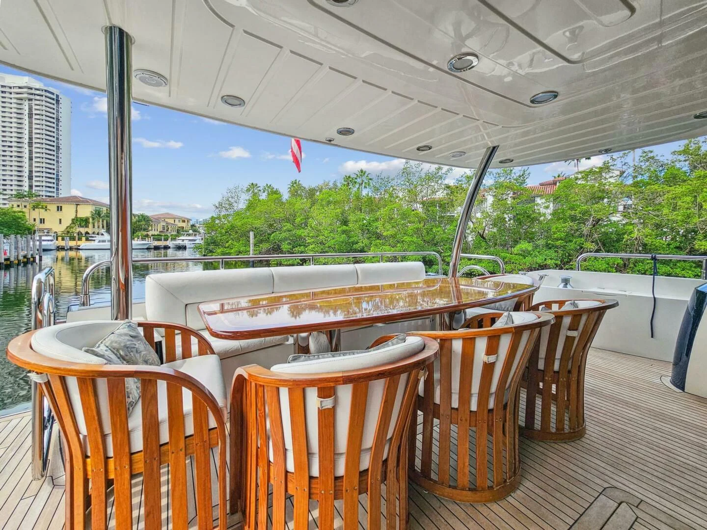 a deck with tables and chairs aboard THE CABANA Yacht for Sale