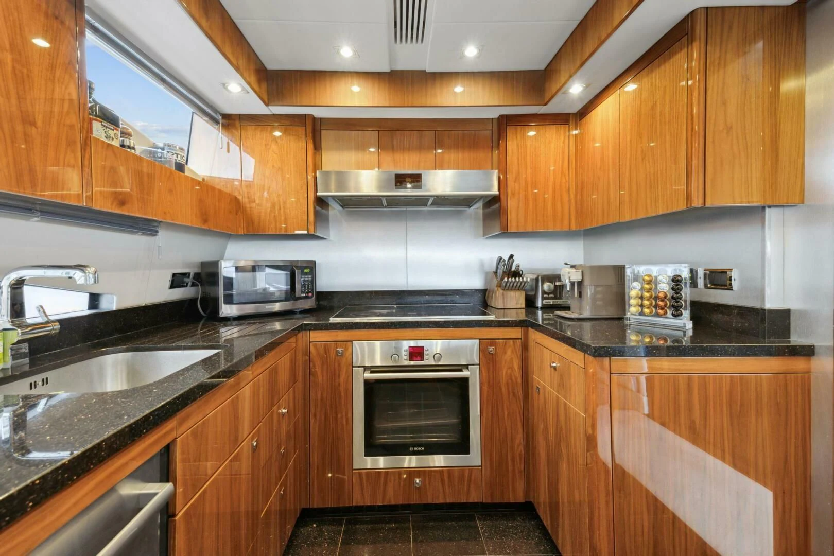 a kitchen with wooden cabinets aboard THE CABANA Yacht for Sale