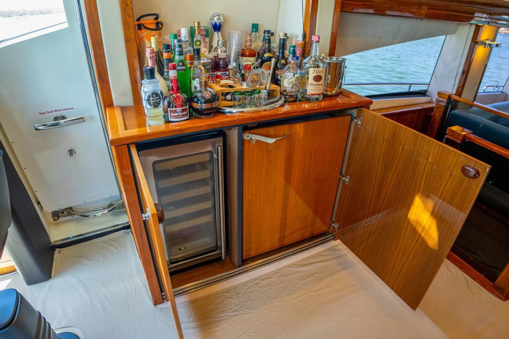 a kitchen with a lot of bottles and cans on the counter aboard THE CABANA Yacht for Sale