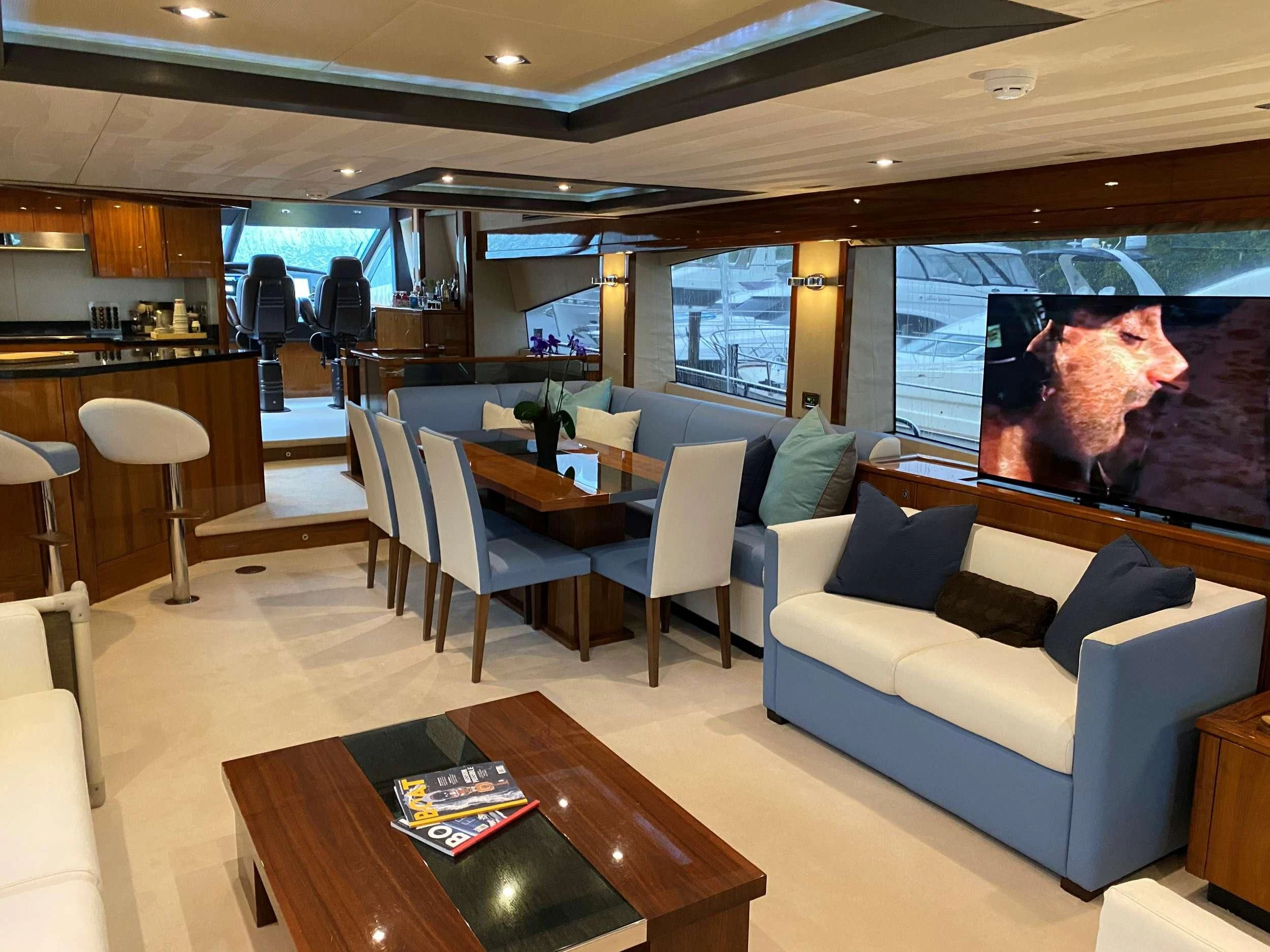 a living room with a large screen aboard THE CABANA Yacht for Sale
