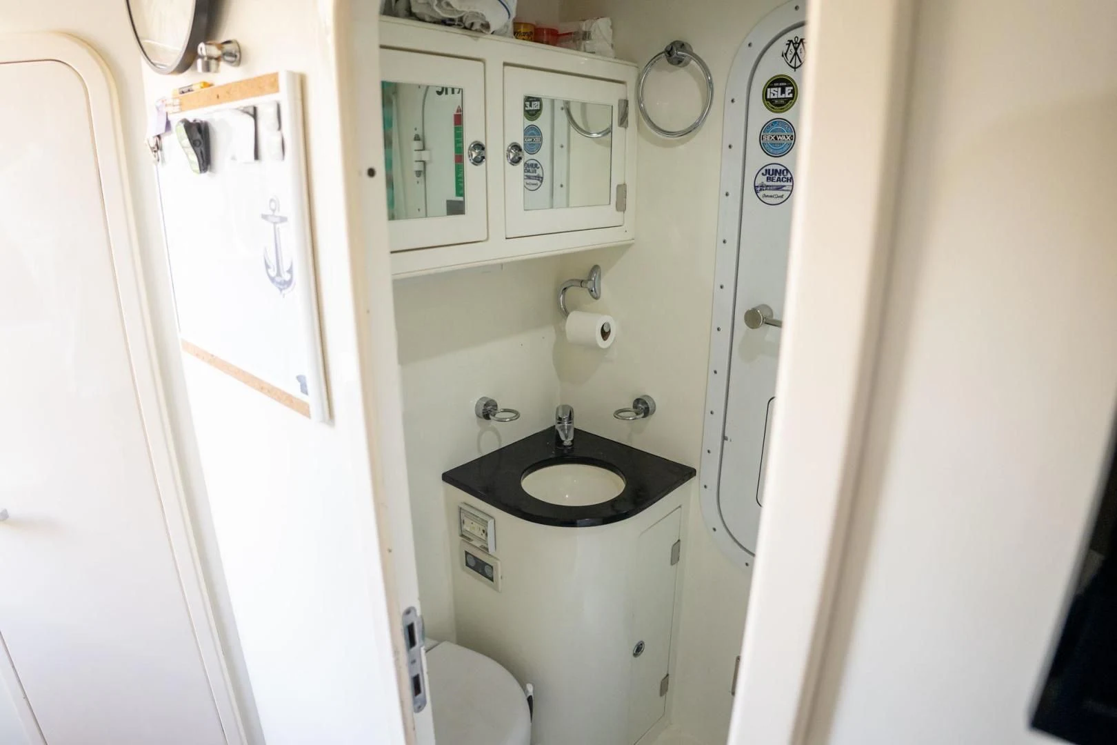 a small bathroom with a sink and toilet aboard THE CABANA Yacht for Sale