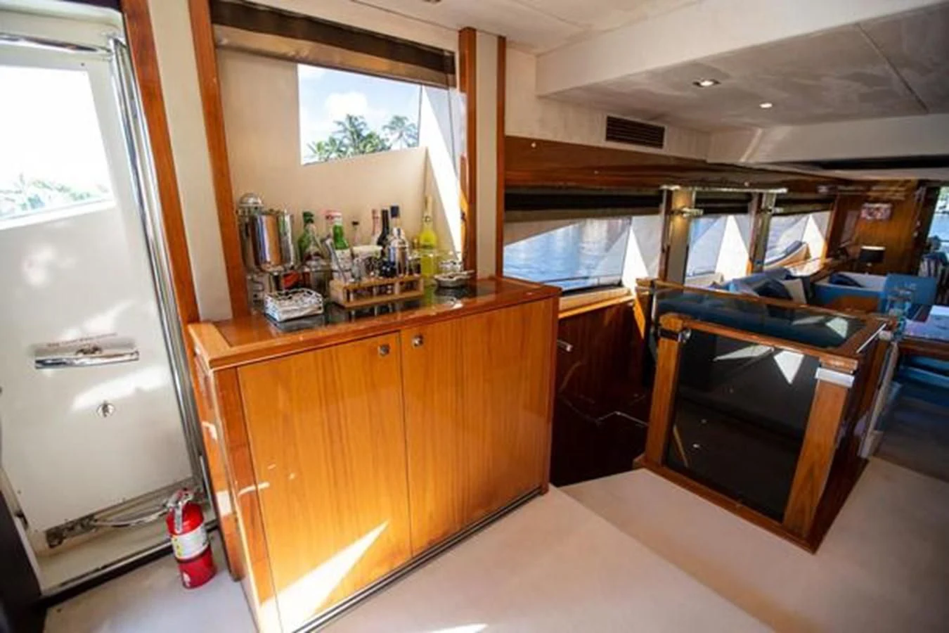a bar with a bar and a counter with bottles of liquor on it aboard THE CABANA Yacht for Sale