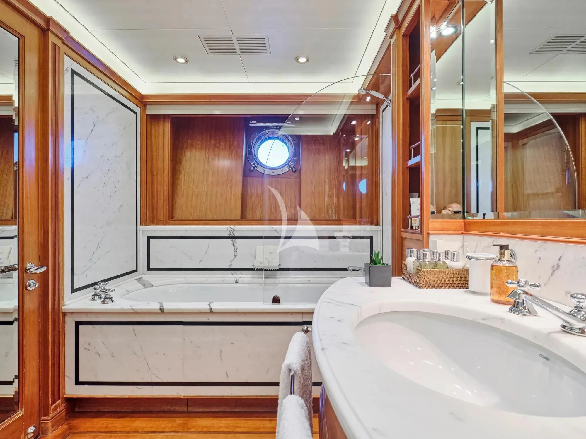 a bathroom with a tub sink and a mirror aboard BURRASCA Yacht for Sale