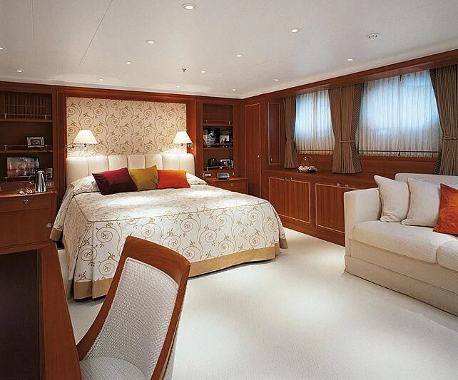 a bedroom with a bed and a couch aboard BURRASCA Yacht for Sale