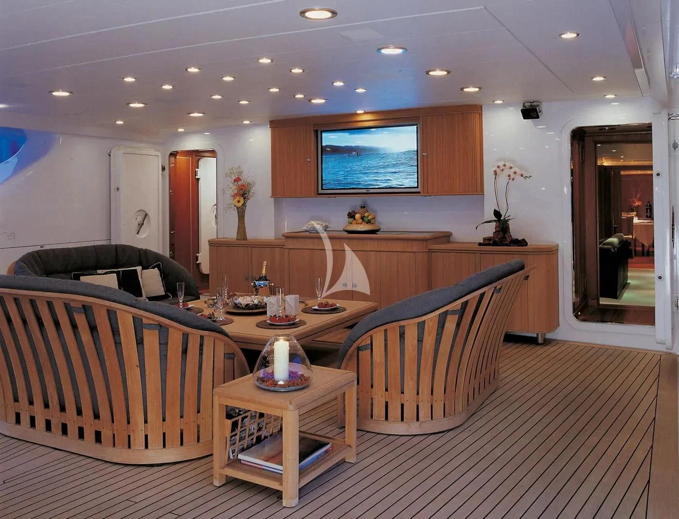 a living room with a large table and chairs aboard BURRASCA Yacht for Sale