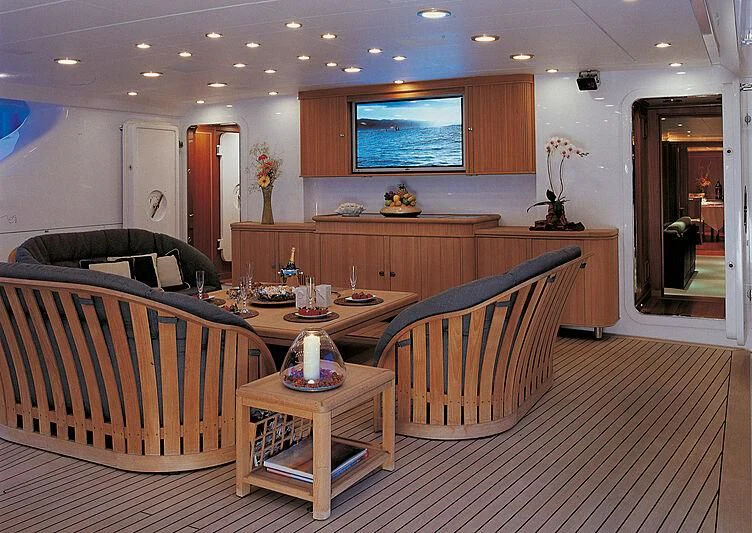a living room with a dining table and chairs aboard BURRASCA Yacht for Sale