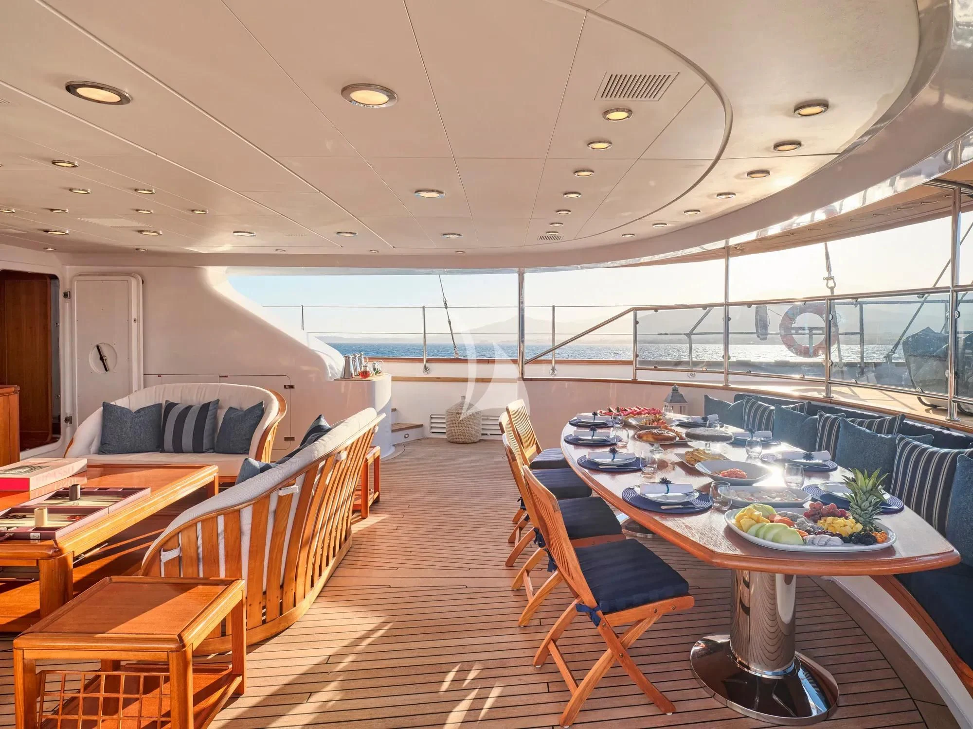 a large room with a table and chairs aboard BURRASCA Yacht for Sale