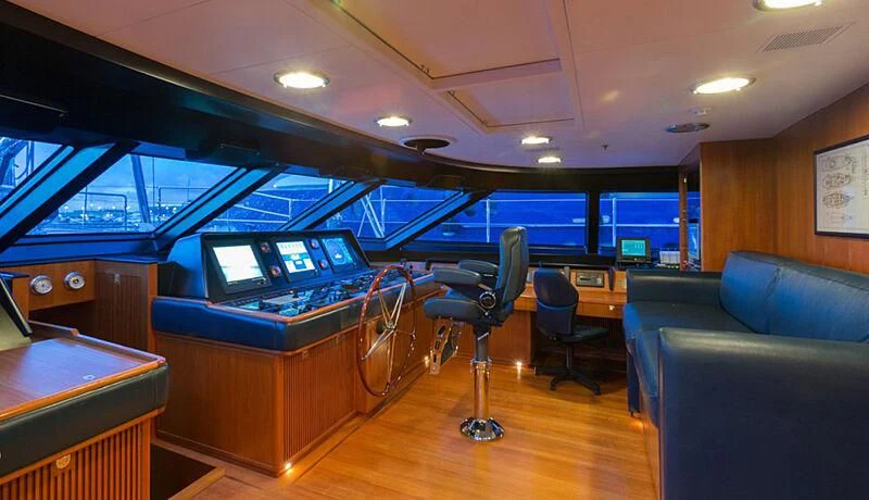 a room with a table and chairs aboard BURRASCA Yacht for Sale