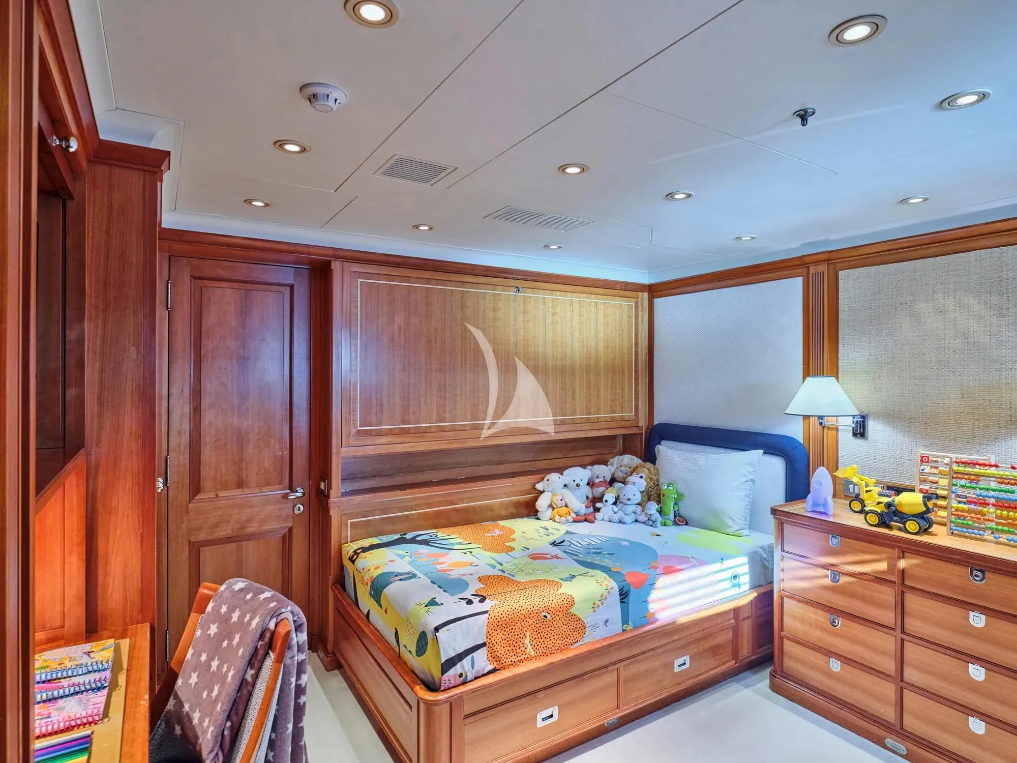 a bedroom with a bed and a dresser aboard BURRASCA Yacht for Sale