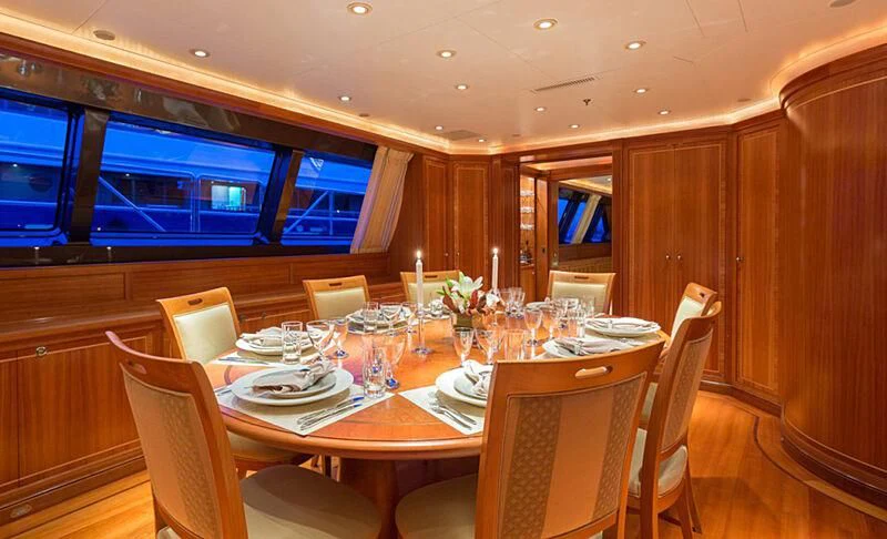 a dining room with a table set aboard BURRASCA Yacht for Sale