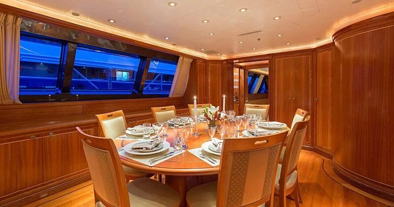 a dining room with a table set aboard BURRASCA Yacht for Sale