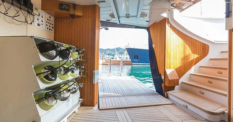 a room with a wood deck and a boat and a large window aboard BURRASCA Yacht for Sale