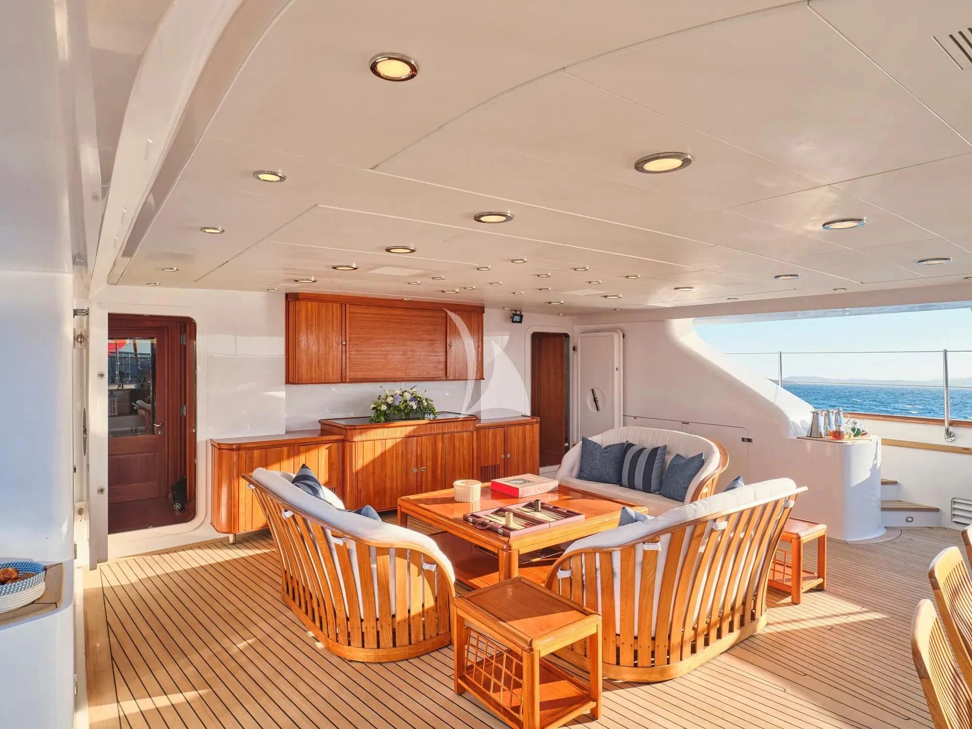 a living room with a large balcony aboard BURRASCA Yacht for Sale