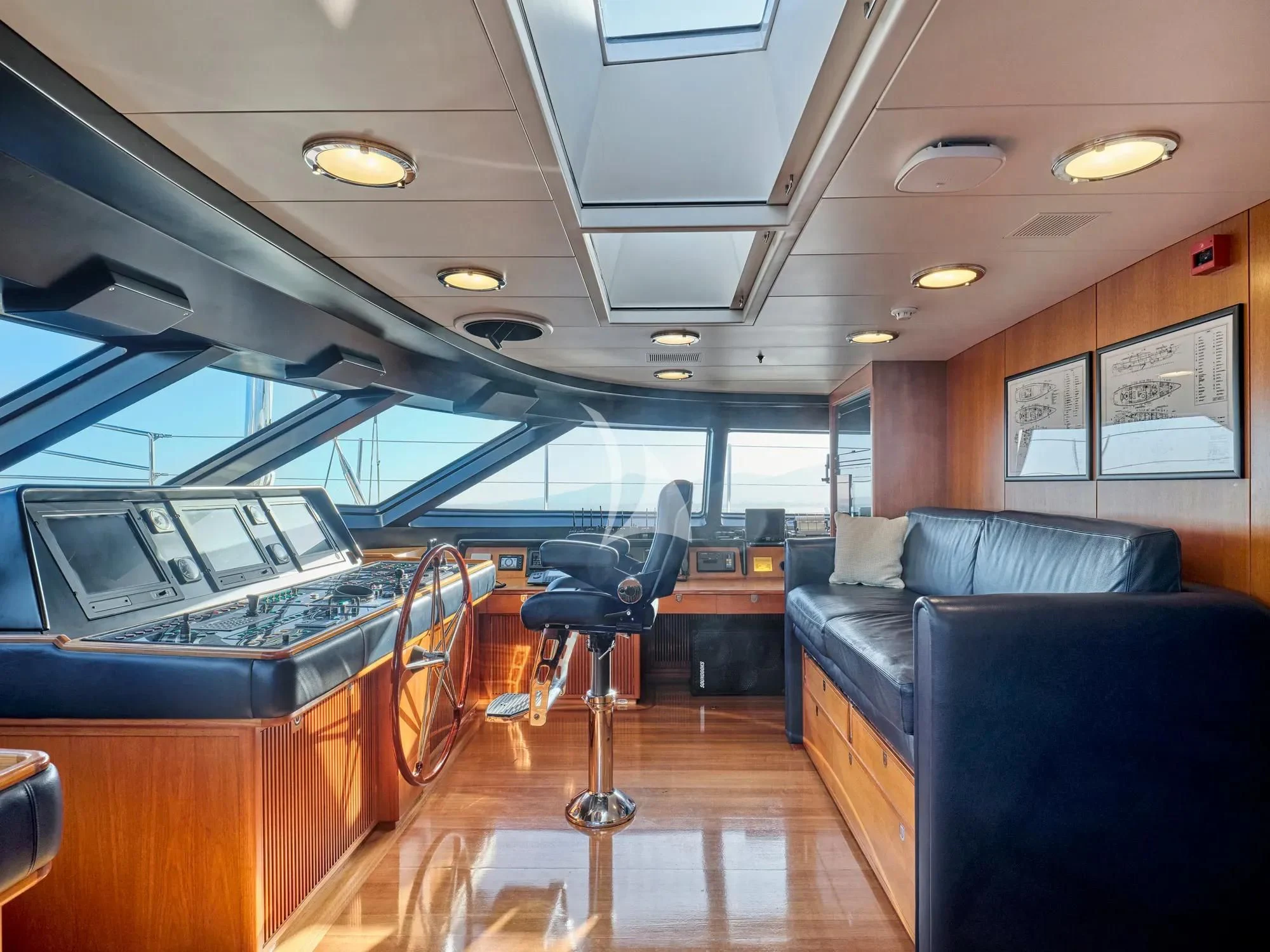 a room with a couch and a chair aboard BURRASCA Yacht for Sale
