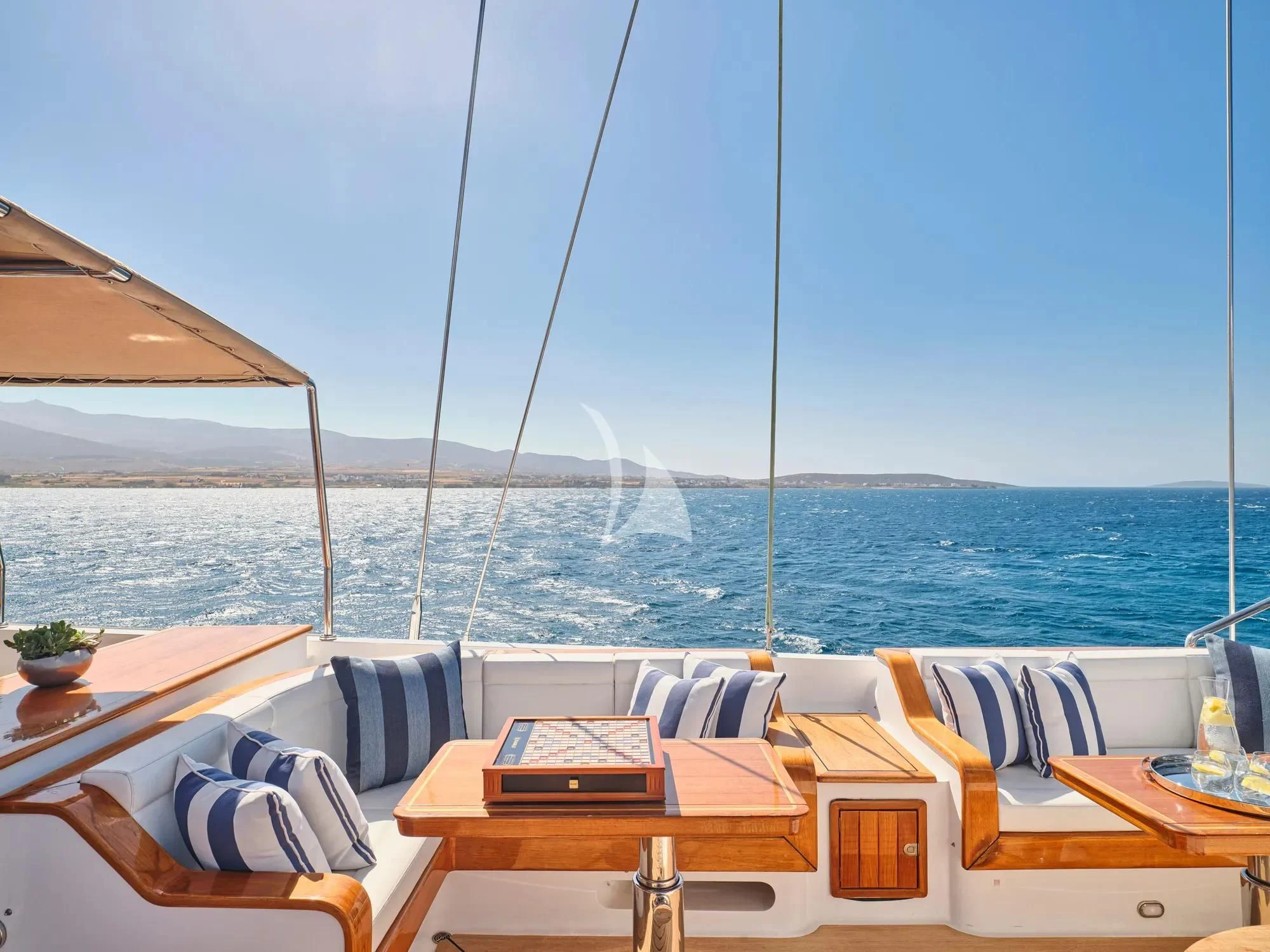a deck with chairs and tables on it aboard BURRASCA Yacht for Sale