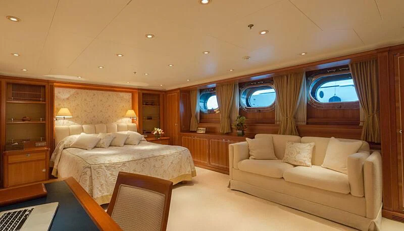a room with a bed and a couch aboard BURRASCA Yacht for Sale