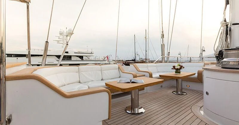 a room with a couch and a table aboard BURRASCA Yacht for Sale
