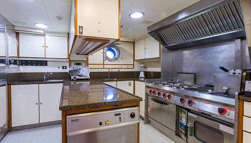 a kitchen with white cabinets aboard BURRASCA Yacht for Sale